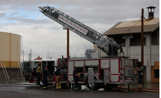 Ladder lifts from the back of a fire truck